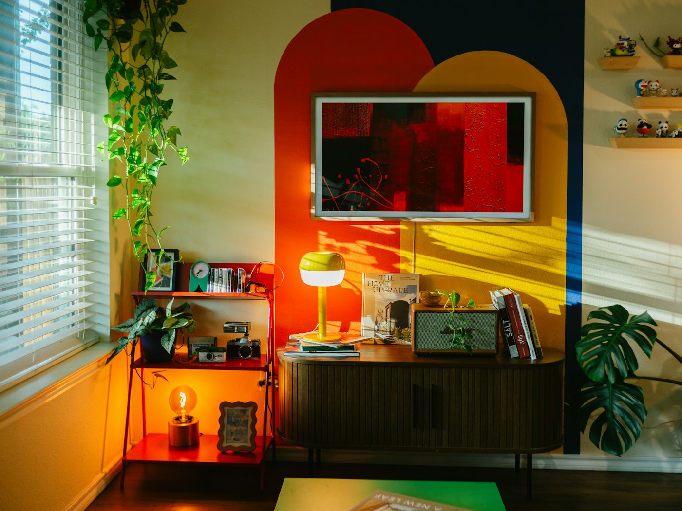 Living room with a bold red and saffron statement wall
